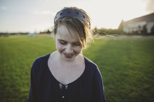 Cute middle school aged caucasian girl happy in windy field