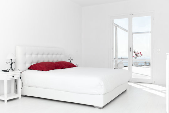White Bedroom with Red Pillows