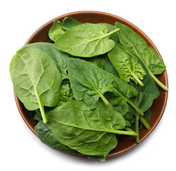 spinach leaves in bowl isolate on white background top view