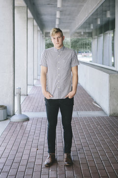 Casual Young Man Standing in Walkway
