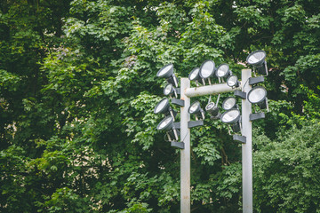 spotlight on a pole against the forest background