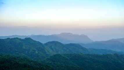 mountain view with mist and sunset on blue sky