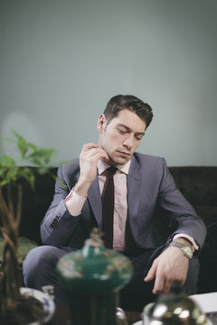Stylish Man in Suit  Scratching 5 o'clock Shadow of Beard