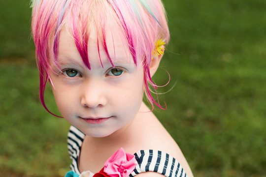 young girl with flower behind her ear