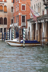 Fototapeta na wymiar Grand Canal, vintage buildings, parked boats at the marina, Venice, Italy