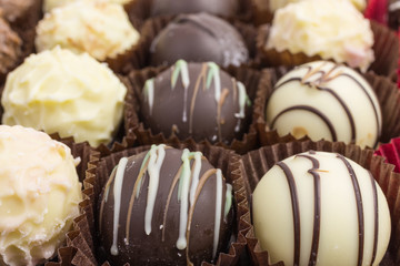 differently decorated white and brown chocolate truffles