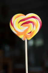 heart shaped lollipop on black background