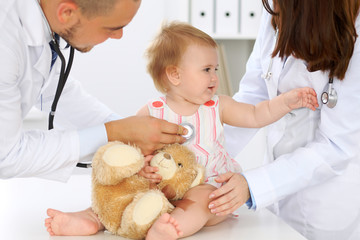 Doctor and patient. Happy cute baby  at health exam. Medicine and health care concept