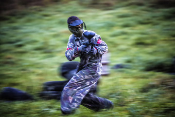 Paintball player aiming and running