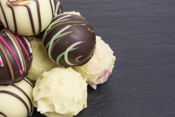 differently decorated white and brown chocolate truffles
