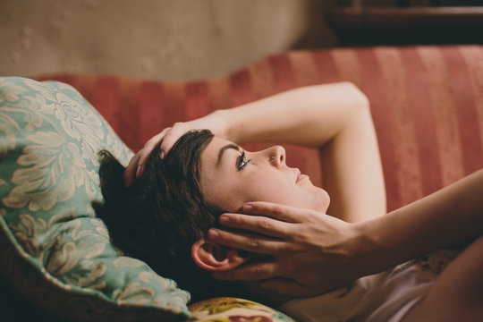 Closeup of a beautiful girl lying on vintage couch