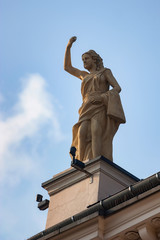 Fototapeta premium Female statue on roof in Krakow, Poland