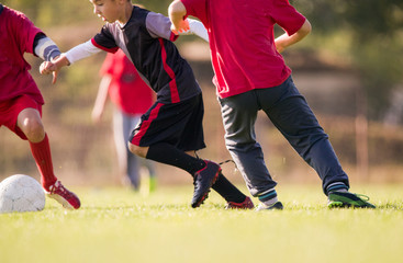 Obraz premium Kids soccer football - children players match on soccer field