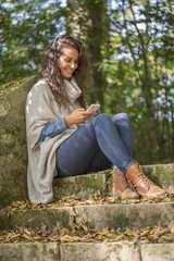 Woman using smartphone in fall season