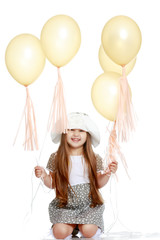 Little girl is playing with a balloon