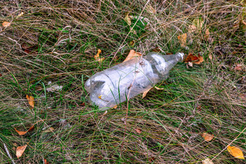 White plastic bottle in the grass