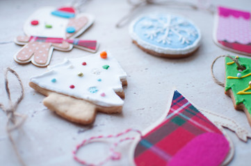 Diversity of Christmas toys - the flat wooden and textile toys and the gingerbread cookies in the different shapes.