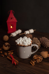 Christmas background - Cup of hot chocolate on wood table with rustic decoration. vintage color tone style. Veretical