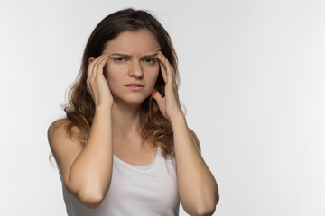 Young girl experiencing headache or depression and mourned over white background