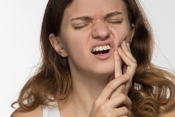 Fototapeta premium Young beautiful giirl on white background with toothache