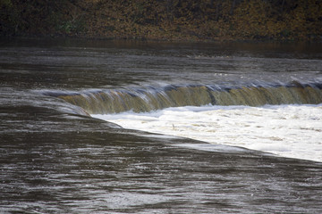 Fototapeta na wymiar The widest waterfall in Europe in Latvia Kuldiga. River Venta.