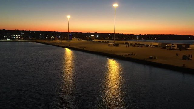 a peaceful harbor or port during sunset view, with road lights and sea water. The harbor is located in Kyllini, near Zakynthos island in Ionian Sea, Mediterranean, greece. 4k video.
