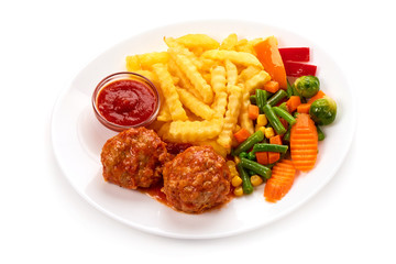 Fototapeta premium Meatballs in tomato sauce with potatoes fries and vegetables, isolated on white background