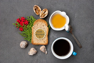 Obraz na płótnie Canvas Wallpaper with breakfast black coffee, toast and honey and text hello december.