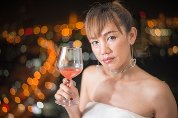 lonely asian woman with red cocktail