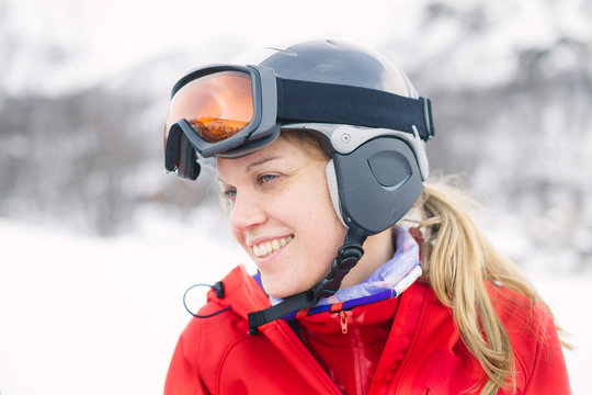 Women with helmet and googles ready for skiing with a smile