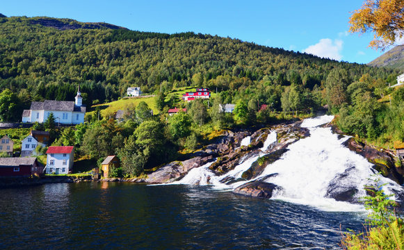 Waterfall in Hellesylt, a small town at the entrance to Geirangerfjord on a sunny summer day