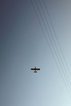 Plane with powerlines