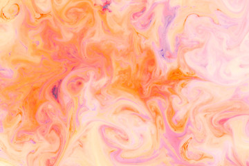Artistic abstract design created with mixing color liquids. Colorful background texture. Liquids mixing on water surface