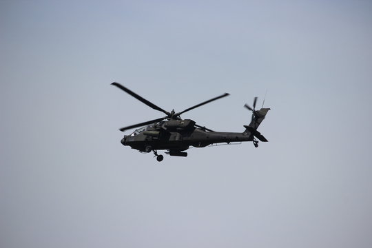 Apache helicopter in flight on military exercise mission.