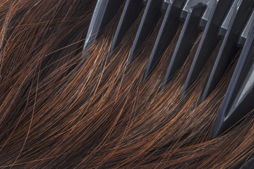 Comb combing brown hair