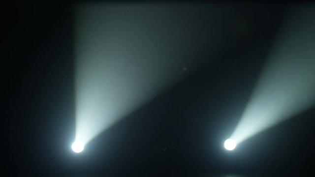 Realistic footage of stage light flashing rays spotlights through smoke. Great as a natural stage background for different projects!!!