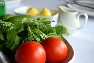 Traditional plate with fresh tomatoes, cucumbers and greens in Azerbaijan