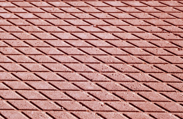 Red color cement floor pattern with blur effect.