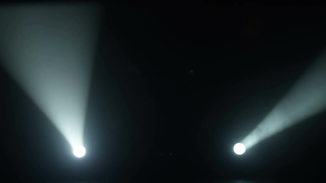 Realistic footage of stage light flashing rays spotlights through smoke. Great as a natural stage background for different projects!!!