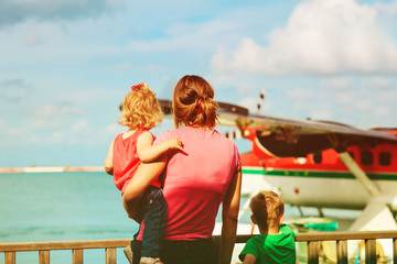 Fototapeta na wymiar mother and kids waiting for sea plane, family travel