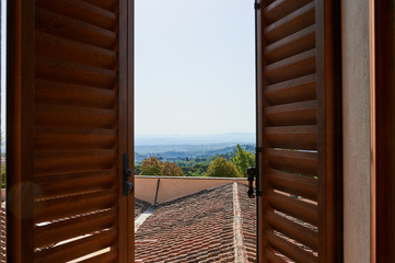 View of hills and forest from a window in Tuscany