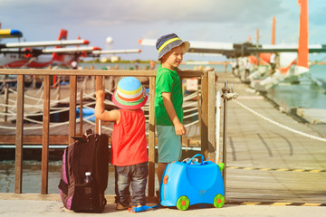 little boy and girl waiting for seaplane, travel concept
