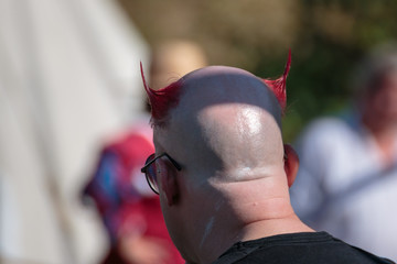 Bald Man with Unique Hairstyle with Red Horns: Rear View Portrai