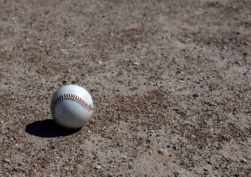 Close-up of baseball on gravel surface