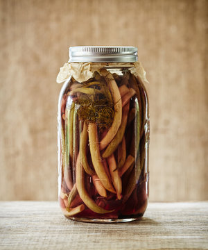 Still life of fermented pickled yellow and green beans in mason jar
