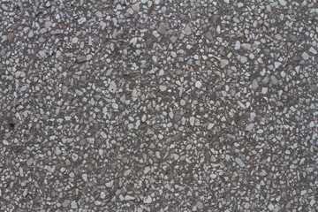 gray concrete sanded with pieces of white pebbles and marble