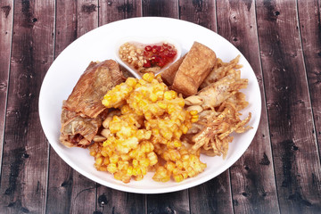 Deep fried dessert of sweet corn,tofu ,taro and  spring roll served with spicy sweet sauce.