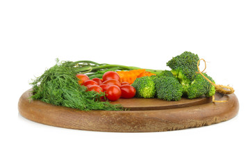 dill. baby tomatoes. carrot. broccoli. on old chopping borad wooden. on isolated on white background