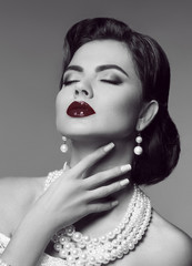 Sensual red lips. Elegant passion retro woman portrait with fashion jewelry set. Black and white vintage photo.