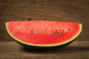 slice of ripe watermelon on old wood